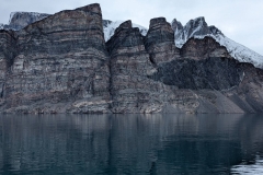 Canada, Nunavut -  Baffin Island, Icy Arm Fjord - Black oval Shape is a  Mafic (basaltic) Boudin,  dark  layer that breaks during deformation  while Surrounding quartz-bearing layers flow